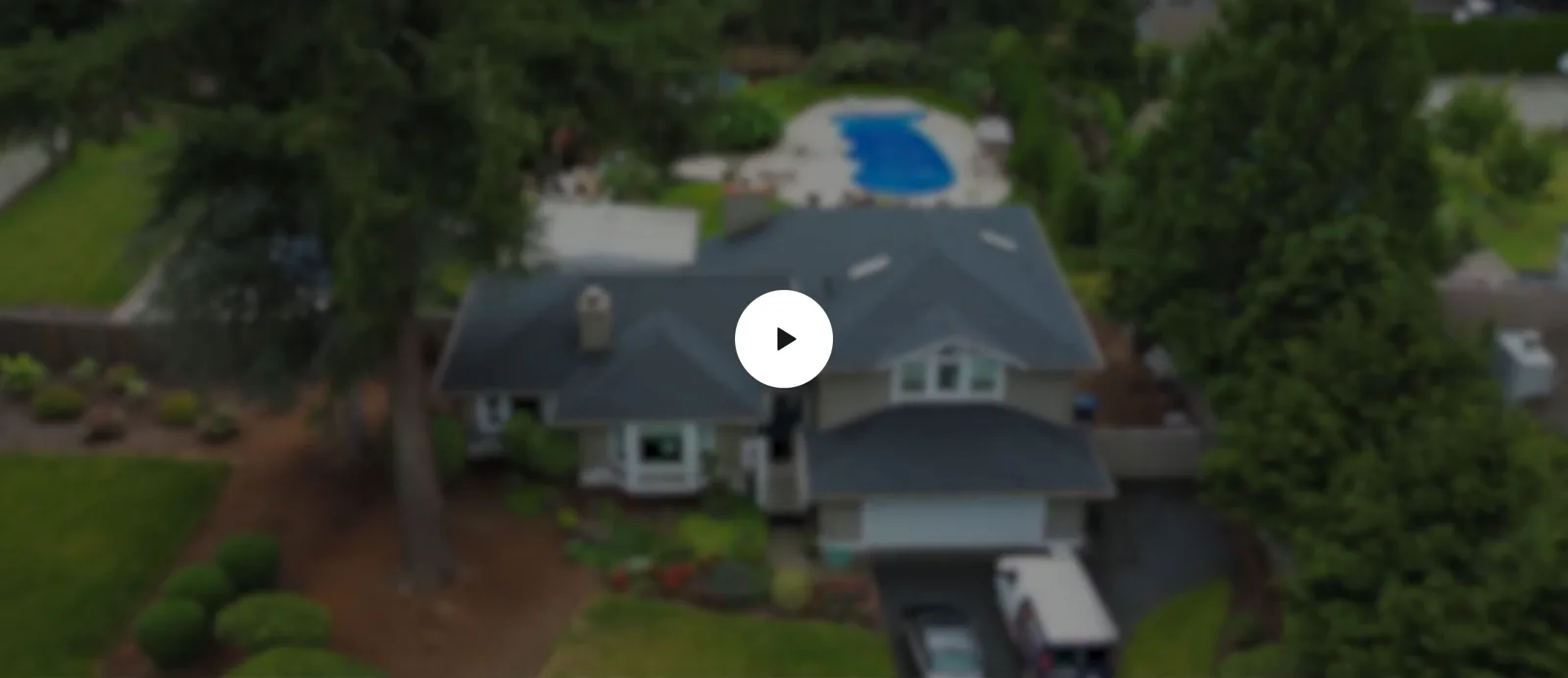 Aerial view across a residential roof and the surrounding neighborhood
